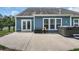 Home exterior featuring patio, hot tub, and tidy blue siding at 3925 Riley-Hampton Dr., Myrtle Beach, SC 29579
