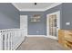 Serene Bedroom with a white crib, gray walls, and ample shelving at 3925 Riley-Hampton Dr., Myrtle Beach, SC 29579