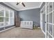Cozy Bedroom with a white crib, neutral carpet, and a ceiling fan at 3925 Riley-Hampton Dr., Myrtle Beach, SC 29579