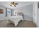 Serene bedroom with soft blue walls, plush carpeting, and a comfortable bed with white linens at 3925 Riley-Hampton Dr., Myrtle Beach, SC 29579