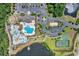 Aerial view of the resort-style community pool, clubhouse, tennis court, and playground, set by the lake at 3925 Riley-Hampton Dr., Myrtle Beach, SC 29579