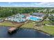 Aerial view of community pool featuring waterslide, dock and lush landscaping at 3925 Riley-Hampton Dr., Myrtle Beach, SC 29579