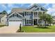 Charming two-story home with a well-manicured lawn, two car garage, and inviting front porch and a balcony above at 3925 Riley-Hampton Dr., Myrtle Beach, SC 29579