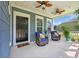 Comfortable front porch featuring cushioned wicker chairs, ceiling fans, and a 'hello' welcome mat at 3925 Riley-Hampton Dr., Myrtle Beach, SC 29579