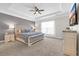 Bedroom with a tray ceiling, neutral decor, and ample natural light at 3925 Riley-Hampton Dr., Myrtle Beach, SC 29579