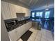 Kitchen with white cabinets, granite countertops, stainless steel appliances, and tiled floor at 3965 Forsythia Ct. # 202, Myrtle Beach, SC 29588