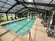 Enclosed pool and sun room with several lounge chairs at 3965 Forsythia Ct. # 202, Myrtle Beach, SC 29588