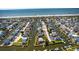 Aerial view showcasing a coastal community with waterfront homes, docks, and beach access at 401 Marlin St., Sunset Beach, NC 28468