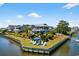 Waterfront home featuring lush landscaping, lounge chairs, and a peaceful waterfront view at 401 Marlin St., Sunset Beach, NC 28468