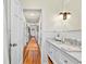 Hallway bathroom featuring marble countertops, modern lighting, and ample storage space for your convenience at 401 Marlin St., Sunset Beach, NC 28468