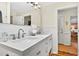 Clean bathroom featuring double sinks, white cabinetry, and modern fixtures at 401 Marlin St., Sunset Beach, NC 28468
