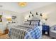 Comfortable bedroom featuring two dressers and a bed with a leafy patterned bedspread at 401 Marlin St., Sunset Beach, NC 28468
