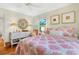 Inviting bedroom with stylish decor, hardwood floors, and a comfortable queen-size bed bathed in natural light at 401 Marlin St., Sunset Beach, NC 28468