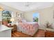 Charming bedroom with ceiling fan, natural light, and a cozy queen-size bed, perfect for relaxation at 401 Marlin St., Sunset Beach, NC 28468