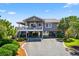 Charming coastal home with a stilt foundation, lush landscaping, and a spacious driveway at 401 Marlin St., Sunset Beach, NC 28468