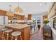 Bright kitchen features wooden cabinets, marble countertops, and stylish pendant lighting at 401 Marlin St., Sunset Beach, NC 28468