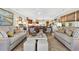 Bright, open-concept living room featuring comfortable seating and hardwood floors at 401 Marlin St., Sunset Beach, NC 28468