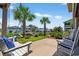 Back patio featuring a swing, rocking chairs, landscaping and view of the homes on the other side of waterway at 401 Marlin St., Sunset Beach, NC 28468