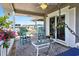 Inviting covered porch with rocking chairs, swing and views of the waterway beyond the other waterfront homes at 401 Marlin St., Sunset Beach, NC 28468