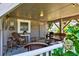Cozy screened porch with seating and views of the neighborhood and waterway beyond at 401 Marlin St., Sunset Beach, NC 28468