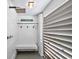 Outdoor shower with white siding and bench for a quick rinse after swimming at 401 Marlin St., Sunset Beach, NC 28468