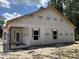 This new home features covered entryway, windows, and exterior wrapped in protective material at 4032 Copperhead Rd., Conway, SC 29527