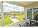 Charming backyard patio with a covered seating area and a picturesque view of the pond at 435 Rollins Dr., Longs, SC 29568