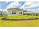 Landscaped backyard with fresh green grass, flower beds and seating on the porch at 435 Rollins Dr., Longs, SC 29568