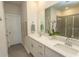 Modern bathroom featuring dual sinks, white cabinets, and a sleek glass-enclosed shower at 435 Rollins Dr., Longs, SC 29568