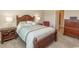 Comfortable bedroom featuring a wooden bed frame, neutral carpet, and dark wooden furniture at 435 Rollins Dr., Longs, SC 29568