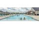 Large community pool with lounge chairs and shady pergola, perfect for a swim! at 435 Rollins Dr., Longs, SC 29568