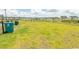 Community dog park with lush green grass and dog waste disposal stations at 435 Rollins Dr., Longs, SC 29568