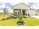 Charming home featuring stone accents, a well-manicured lawn, and a welcoming front porch at 435 Rollins Dr., Longs, SC 29568