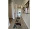 Inviting hallway with light wood floors, contemporary rugs, and stylish decor at 435 Rollins Dr., Longs, SC 29568