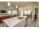 Open-concept kitchen with stainless steel appliances, island, and sink with backyard view at 435 Rollins Dr., Longs, SC 29568