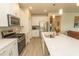 Well-equipped kitchen with stainless steel appliances, a spacious island, and bright cabinetry at 435 Rollins Dr., Longs, SC 29568