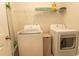 Efficient laundry room with modern washer and dryer, plus storage shelves at 435 Rollins Dr., Longs, SC 29568