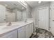Bathroom with double sink vanity, white cabinets, and tile flooring at 4355 Rivergate Ln. # F, Little River, SC 29566