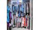 Spacious walk-in closet with hanging rods and shelves filled with an extensive wardrobe collection at 4355 Rivergate Ln. # F, Little River, SC 29566
