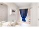 Cozy bathroom with a bathtub and shower, toilet, and a blue shower curtain at 4522 N Plantation Harbour Dr. # E7, Little River, SC 29566