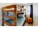 Cozy bedroom featuring a rustic wooden bunk bed, soft linens, and a convenient bedside table at 4522 N Plantation Harbour Dr. # E7, Little River, SC 29566