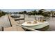 View of a boat docked on a canal with waterfront homes in the background, offering a scenic coastal lifestyle at 4522 N Plantation Harbour Dr. # E7, Little River, SC 29566