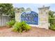Entrance sign for Carolina Yacht Landing, surrounded by lush greenery, welcomes residents and visitors at 4522 N Plantation Harbour Dr. # E7, Little River, SC 29566