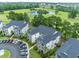 Expansive aerial view of the condo complex next to a serene pond, surrounded by lush green trees and well-kept grounds at 468 River Oak Dr. # 66D, Myrtle Beach, SC 29579