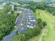 Extensive aerial view highlighting the community's numerous condo buildings, vast parking areas, and adjacent golf course at 468 River Oak Dr. # 66D, Myrtle Beach, SC 29579