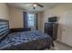 This neutral bedroom has a large window, ceiling fan, and a television at 468 River Oak Dr. # 66D, Myrtle Beach, SC 29579
