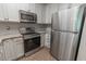 Clean kitchen featuring stainless steel appliances, white cabinetry, and granite countertops with tile backsplash at 468 River Oak Dr. # 66D, Myrtle Beach, SC 29579