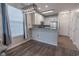 Bright eat-in kitchen with stainless steel appliances, white cabinets, and wood floors for a modern and inviting atmosphere at 468 River Oak Dr. # 66D, Myrtle Beach, SC 29579