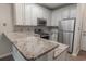 Bright kitchen featuring stainless steel appliances, granite countertops, and white cabinetry for a modern, clean aesthetic at 468 River Oak Dr. # 66D, Myrtle Beach, SC 29579