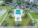 Aerial view of a community pool area with lounge chairs, tables, and a small pool house, bordered by well-kept landscaping at 468 River Oak Dr. # 66D, Myrtle Beach, SC 29579